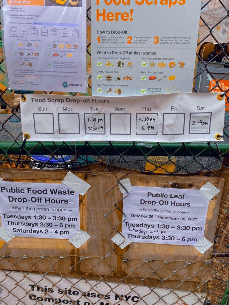Sign postings about food scraps and food waste drop off info placed on a wire fence. 